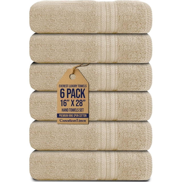 Canadian Linen Luxury Everest Hand Towels, 16”x28”, 6 Pack, in beige color, made from soft, absorbent, and lightweight cotton. The towels feature a decorative twill bead border design and are neatly stacked with a branded tag displaying product details. Suitable for kitchens, gyms, hotels, and massage settings.
