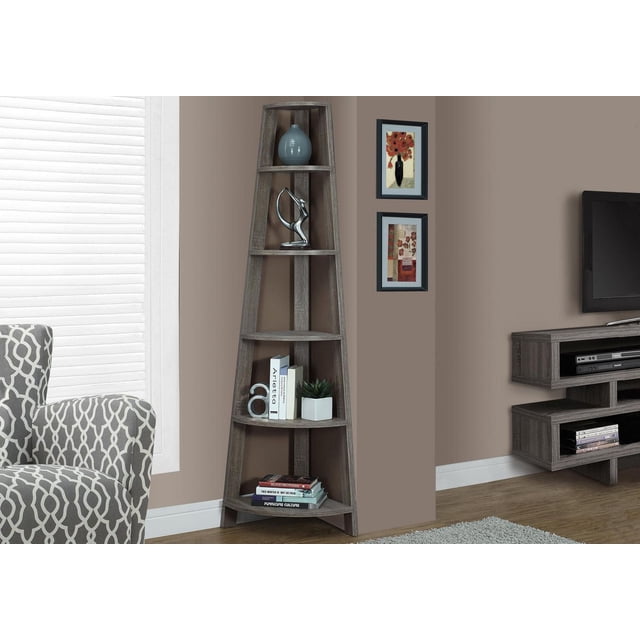 Monarch Specialties Inc Monarch Specialties Bookcase - Cappuccino, 72"H, a corner accent étagère bookcase with five fixed tray-style shelves in dark taupe wood-look finish, holding decorative items including a blue vase, silver abstract sculpture, books, and a small potted plant, placed in a living room corner with beige walls, framed floral artwork, patterned armchair, and floating media console.