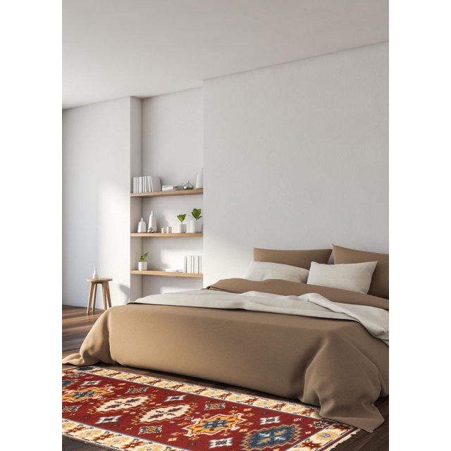 ECARPETGALLERY 100% Wool Traditional Indoor Area Rug with bold geometric Persian Kazak-inspired patterns in red, blue, yellow, and cream, placed on dark hardwood flooring in a minimalist bedroom with beige bedding and wooden shelves, ideal for entrance, bedroom, living, or dining rooms.