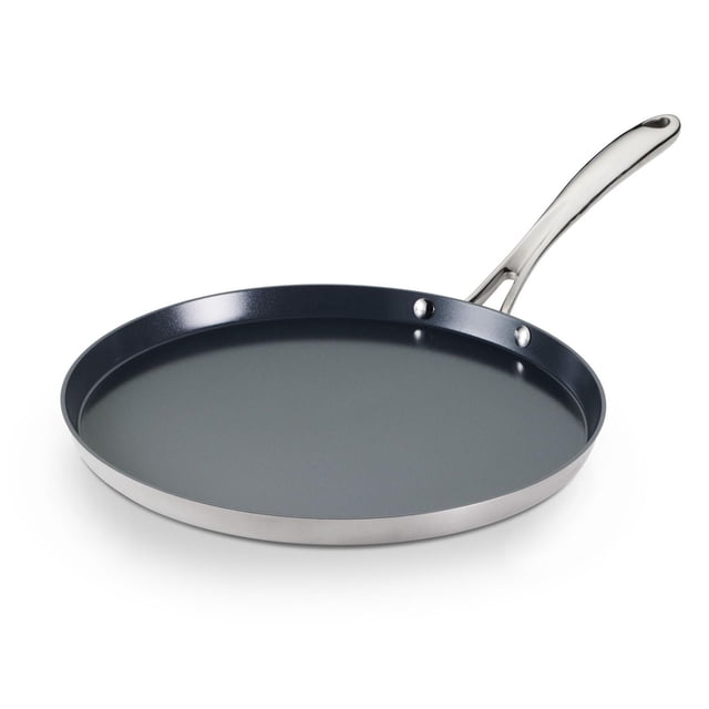 Tramontina Utsava Tri-Ply Clad Stainless Steel Ceramic Nonstick Dosa Tawa with a flat round shape, dark grey ceramic nonstick surface, polished stainless steel tri-ply base, and ergonomic stay-cool stainless steel handle, ideal for dosas, flatbreads, and compatible with all cooktops including induction and oven-safe to 400ยฐF.