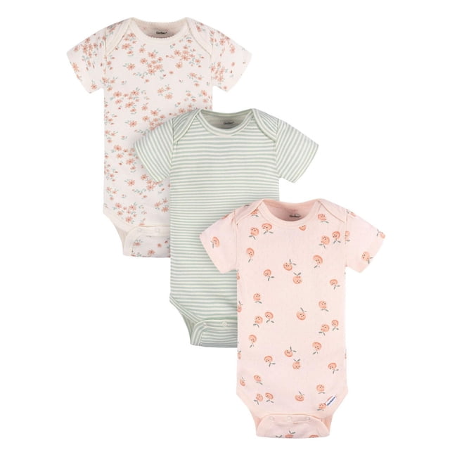 Gerber 3 pack Onesies with three baby girl bodysuits in a front view: one with peach floral print on white, one with green and white stripes, and one with peach fruit motifs on light peach fabric, all featuring lap shoulder necklines and snap closures for easy diaper changes.