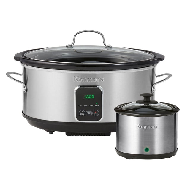 Kenmore Programmable 7 QT (6.6L) Slow Cooker and Dipper in black and silver. Features a large 7-quart capacity, digital LED display, and four temperature settings: Low, Medium, High, and Warm. Includes a dipper warmer for sauces and dips. The slow cooker has a stainless steel exterior with black accents, a tempered glass lid, and non-slip rubber feet for stability. Both the ceramic insert and lid are dishwasher safe.