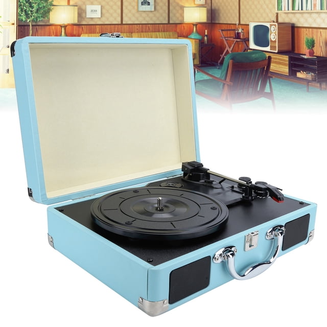 Turntable, 33/45/78 RPM album player in a blue suitcase design, featuring built-in stereo speakers, a highly sensitive stylus, and support for 7/10/12 inch vinyl records. The record player includes a 3.5mm earphone and auxiliary input jack for connecting smartphones, MP3 players, and other digital audio devices. Shown in an open position with a retro-style room in the background.
