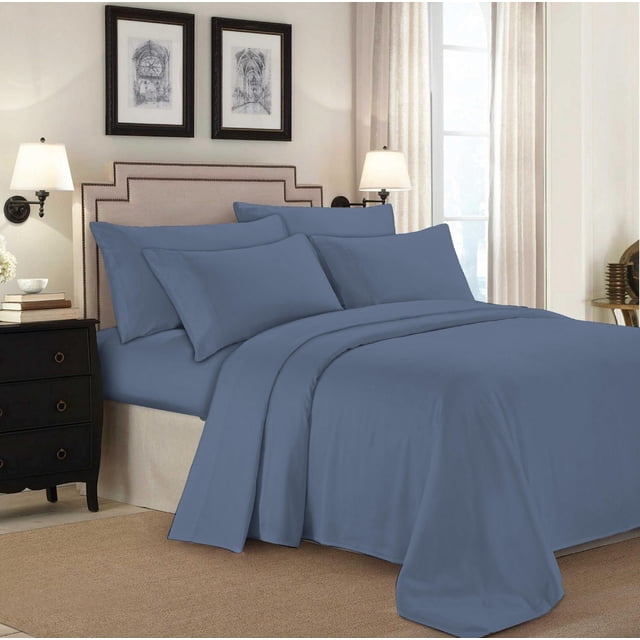 Johnson Home 500 Thread Count Certified Organic Cotton Sheet Sets in blue on a bed with a beige upholstered headboard featuring nailhead trim, including matching pillowcases and flat sheet, in a softly lit bedroom with cream walls, framed architectural prints, wall lamps, and beige curtains, providing breathable, hypoallergenic comfort suitable for year-round use.