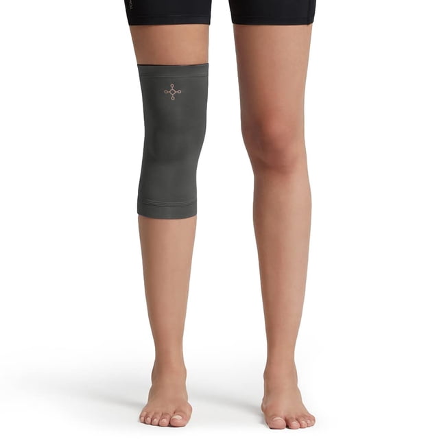 Tommie Copper Unisex Core Compression Knee Sleeve in slate grey, size XX-Large, shown worn on the left leg. Made from polyester, this lightweight knee sleeve provides support and compression for joint stability and recovery.