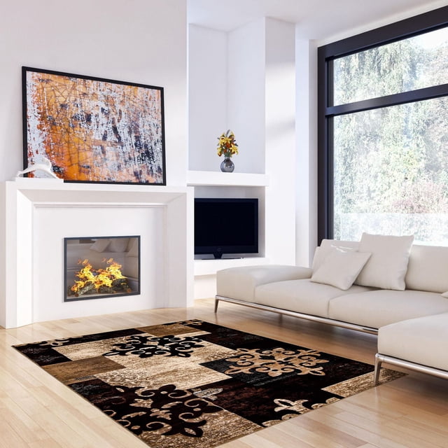 Traditional indoor area rug from Ecarpet Maizy Collection featuring black, beige, and brown patchwork patterns on light wood floor of bright living room with white sofa and fireplace.