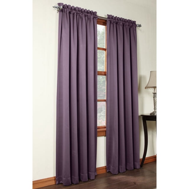Sun Zero Madrid Grommet Curtains set of 2 in deep purple, room darkening and energy-efficient panels with gathered tops, hanging on a silver decorative rod over a wooden window frame in a room with light walls and dark hardwood floors, also suitable for enhancing privacy in living areas.