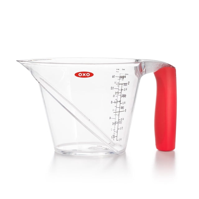 OXO Softworks 2 Cup Angled Measure Cup with clear plastic body and red ergonomic handle, featuring a patented angled surface for easy top-view reading of cups, ounces, and milliliters, ideal for precise kitchen measuring and suitable for portion control.