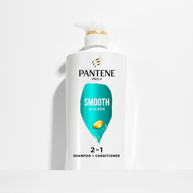 Pantene Smooth & Sleek 2-in-1 Shampoo & Conditioner, 530mL centered front view of white bottle with gold flip-top cap and Pantene branding; label reads 2-in-1, 530mL and 72-hour smoothness and lists argan and avocado oils. Often used to refresh wigs or hair extensions between washes.
