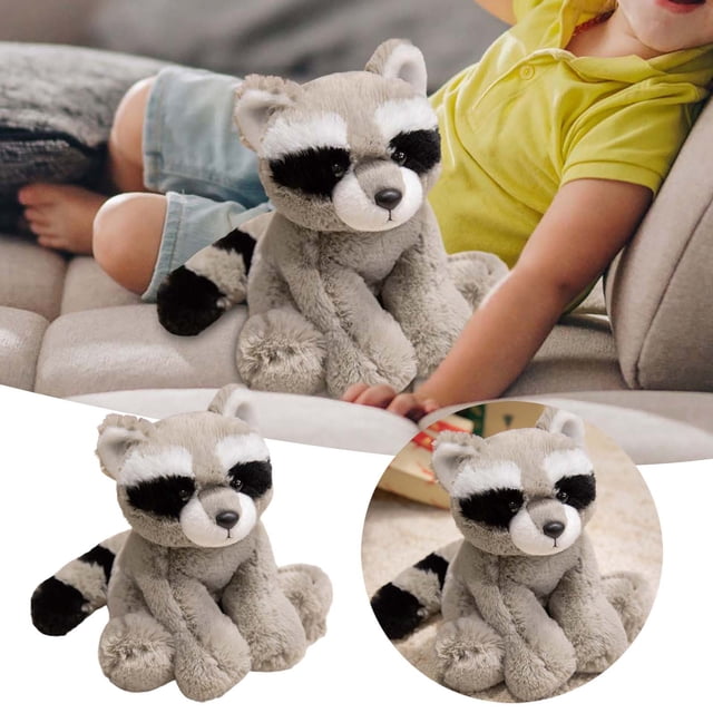 BKER Adorable Raccoon Doll Soft Stuffed Animal Toy for Kids, featuring a grey plush raccoon with realistic black and white facial markings and a striped tail. Made from soft, high-quality materials, this cuddly toy is ideal for children aged 3 and up. Shown in a cozy bedroom setting, it adds a cute and comforting touch to any space. Perfect for imaginative play, companionship, or as a decorative piece for a child's room.