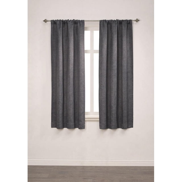 Mainstays Chambray Blackout 63" Window Curtains Panel Pair in dark grey heather texture with 100% blackout triple foam backing and rod pocket design, each panel 40 inches wide and 63 inches long, made of machine washable 100% polyester microfiber, shown hanging on a metal rod covering a window in a neutral room with light walls and wood floor, ideal for bedroom light control and blackout.