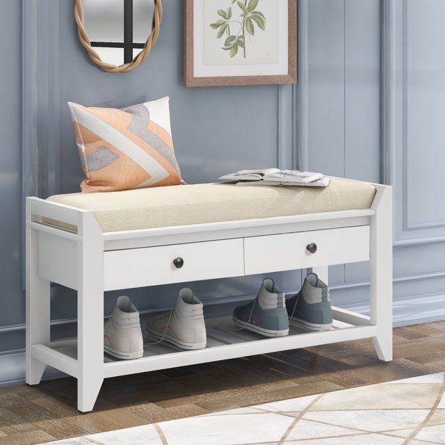 MODERNLUXE 35.4" Shoe Bench Entryway Bench in white with a cushioned beige seat, two storage drawers with matte black knobs, and a bottom shelf for shoes. Made of pine wood with a distressed finish, it features a compact design suitable for entryways, hallways, or bedrooms. The bench includes a gridded base for additional storage and tapered legs for a farmhouse aesthetic.