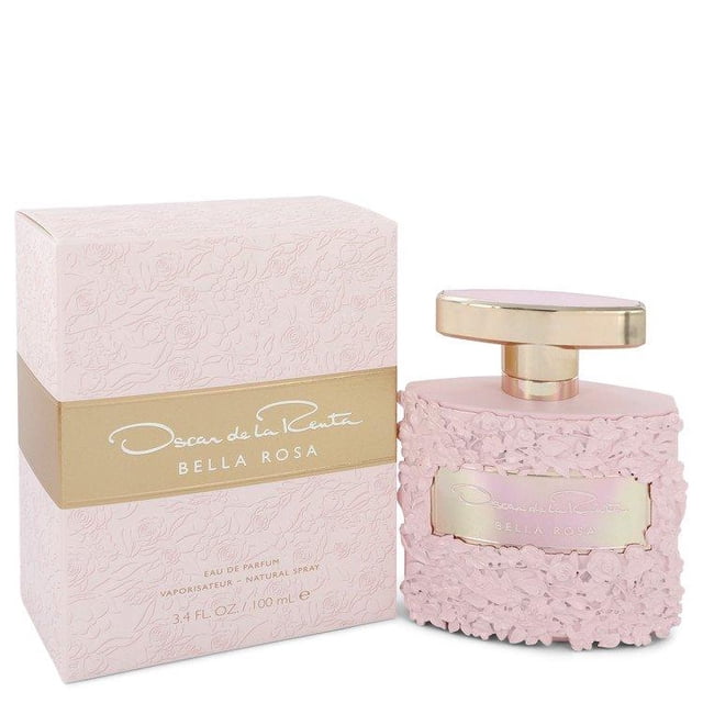 Bella Rosa by Oscar De La Renta Eau De Parfum Spray 3.4 oz for Women, featuring a pink floral-embossed bottle with a gold cap and matching packaging. This Chypre fragrance, launched in 2019, combines fruity, woody, citrus, and floral notes, including pink pepper, freesia, and mandarin orange.