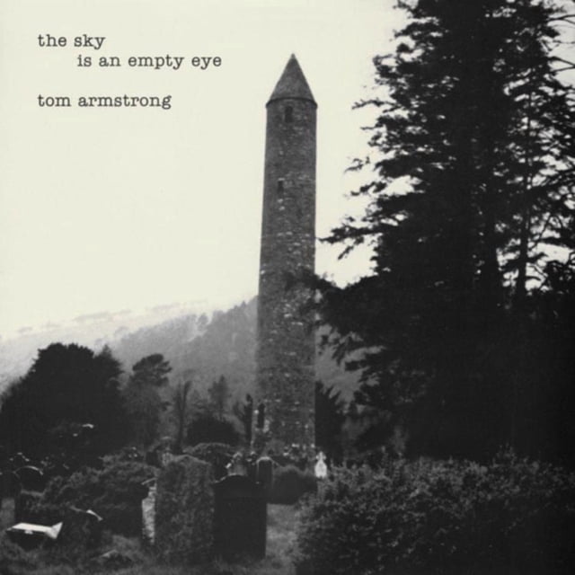 Tom Armstrong - The Sky Is an Empty Eye (vinyl) album cover featuring a black and white photo of a tall stone tower with a conical roof in a graveyard surrounded by tombstones and dense trees, misty hills in the background, with the album title and artist name in typewriter font in the upper left corner.