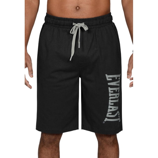 Everlast Loungewear Shorts in black 100% cotton with a loose fit, elastic waistband, and grey adjustable drawstring, featuring two side pockets and the Everlast logo printed vertically on the left leg, shown on a male model from waist to knees, ideal for lounging, sleeping, or casual wear.