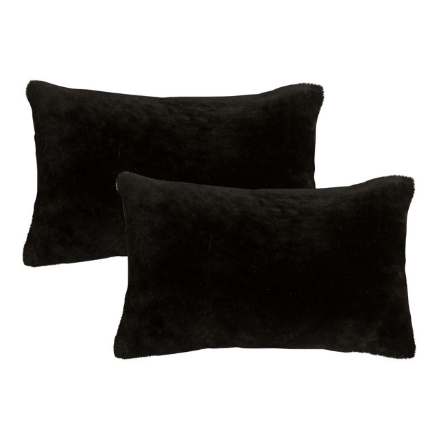 NELSON SHEEPSKIN PILLOW 12"X20" 2-PACK with two black rectangular pillows made from 100% natural sheepskin featuring a 2.5-inch thick pile, hidden zipper closure, and soft microsuede backing, ideal for adding texture and warmth to home décor and suitable for layering with other throw pillows.