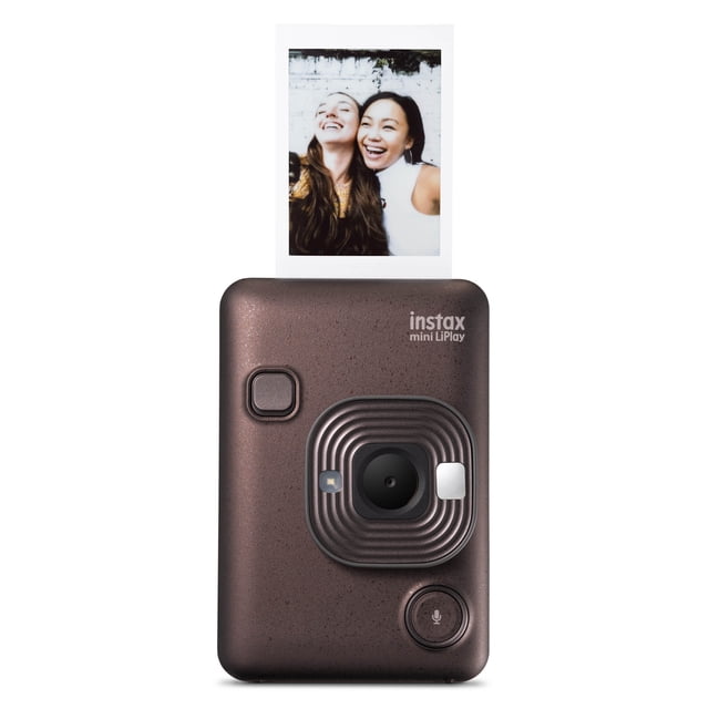 FUJIFILM INSTAX MINI LiPlay Hybrid Instant Camera and Smartphone Printer in deep bronze with a textured finish, showing the front lens, flash, shutter button, and microphone button, printing an instant photo from the top slot.