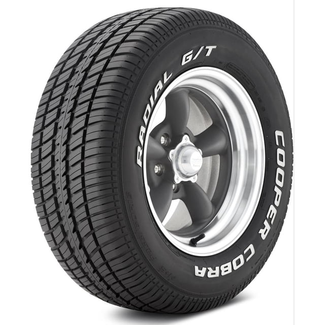 Cooper Cobra Radial G/T P235/60R14 96T WL all-season tire with raised white lettering and even treadwear, mounted on a five-spoke silver and black wheel, designed for classic muscle cars and providing stable grip and control at high speeds.