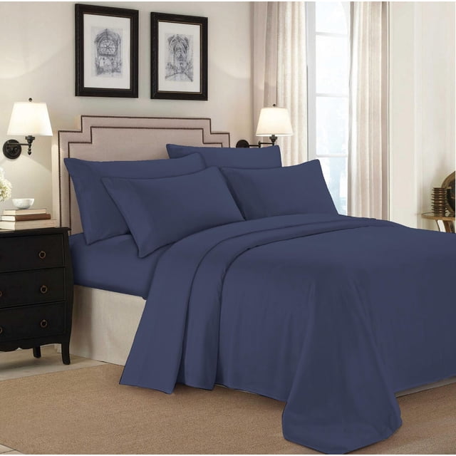 Johnson Home 450 Thread Count Bamboo Bed Sheet Set in navy blue on a bed with matching pillowcases, featuring a beige upholstered headboard with nailhead trim, wall-mounted lamps, and framed artwork in a softly lit bedroom, suitable for year-round comfort and natural allergy relief.