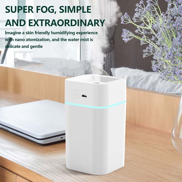 Humidifiers for Bedroom Humidifier Household Bedroom Small Aromatherapy Humidifier Night Light Car USB Plug In. A compact white ultrasonic humidifier made of ABS material, featuring a sleek rectangular design with a soft blue LED light band. It includes a USB power port and a single button for operation. The humidifier is placed on a wooden surface in a cozy bedroom setting, surrounded by a laptop and decorative items. Designed for quiet operation, it uses water atomization technology to improve air quality and maintain skin moisture. Includes a four-hour auto-off function for safety.