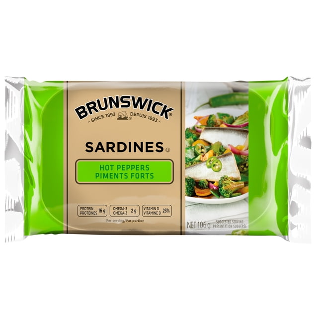 Brunswick Sardines with Hot Peppers in a 106 g beige and green package featuring nutritional information including 16 g protein, 2 g omega-3, and 23% vitamin D per serving, with an image of sardines in soya oil served on a vegetable salad, suitable as a healthy pantry food option.