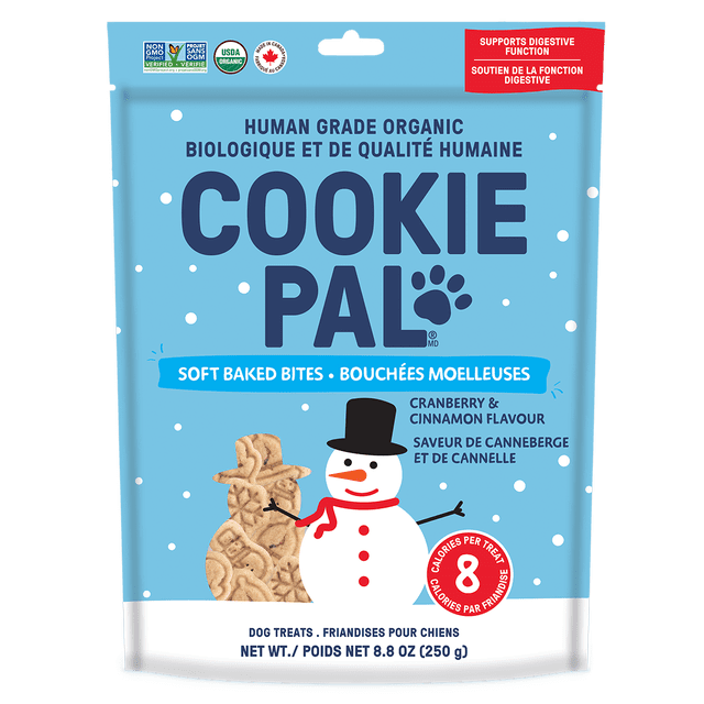 COOKIE PAL Cranberry & Cinnamon Soft Baked Bites human grade organic dog treats 250g in light blue resealable bag with white snow dots and a snowman holding shaped soft baked treats, supporting digestive function and containing 8 calories per treat.