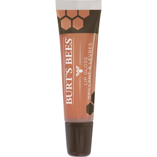 Burt’s Bees 100% Natural Origin Moisturizing Lip Gloss in Flushed Blush, shown in a squeezable tube with a white ribbed cap and dark brown base, featuring honeycomb graphics and white text, providing a hydrating, sheer lip gloss enriched with avocado oil for a natural radiant finish.