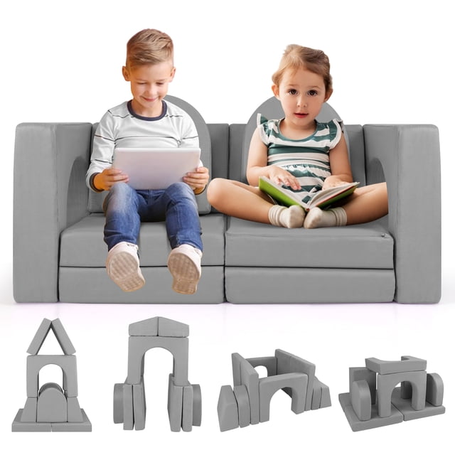 Gymax Canapé Modulable pour Enfants de 8 Pcs en Gris avec Housse en Tissu Suédé et Mousse à Haute Densité. l'Ensemble Comprend 8 Pcs : 2 Coussins, 2 arches, 2 Trapèze et 2 Demi-Lunes, Conçu pour des configurations Polyvalentes comme des tunnels, des forts et des Fosses à Balles. le Sofa Est Présenté dans un Décor de Salon avec des Enfants Assis Dessus, et des configurations Supplémentaires des Pièces Modulables Exposées Ci-Dessous.