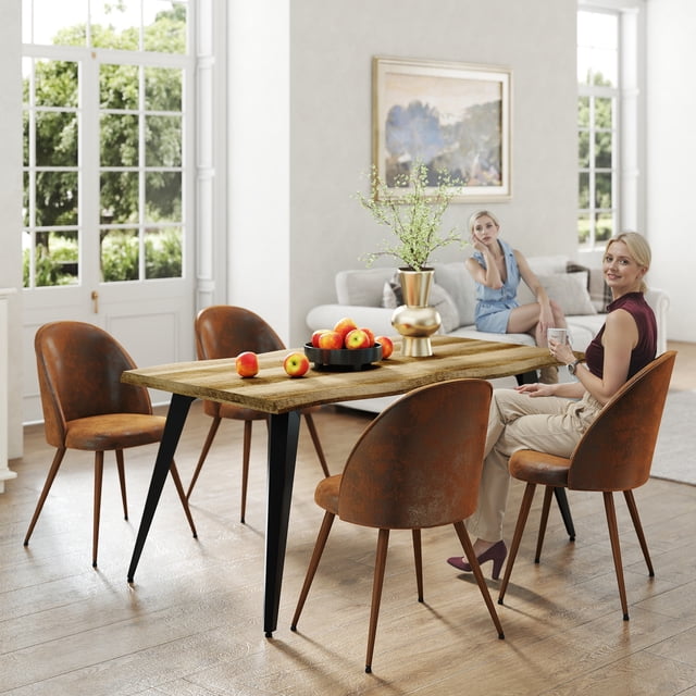 Homy Casa 6-Person Industrial Dining Table with live edge walnut wood-look MDF top and black powder-coated steel legs, 63" x 35", shown with four brown faux leather chairs in a bright dining room with a gold vase holding greenery and a black tray of apples on the table.