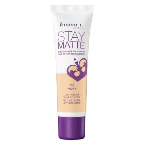 Rimmel Stay Matte Foundation in 100 Ivory, a lightweight liquid mousse foundation with shine control and anti-pollution complex, in a white tube with purple crown logo and cap, offering 24-hour wear and a natural matte finish.