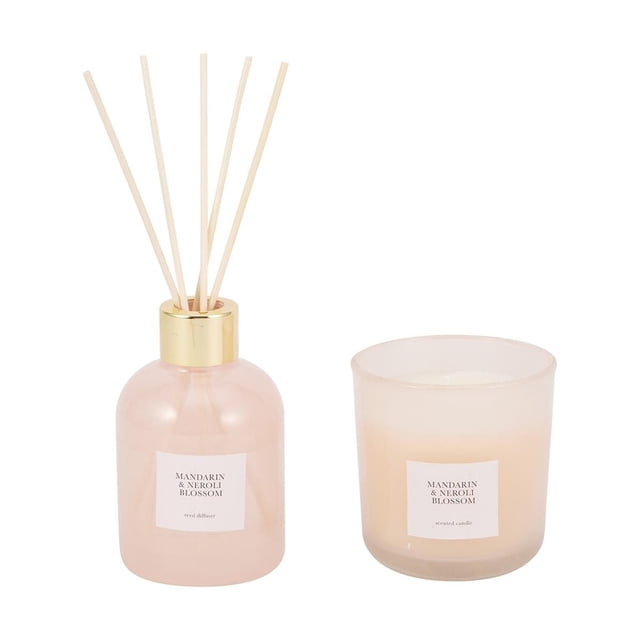 Anko Mandarin & Neroli Gift Set with a pale pink translucent reed diffuser bottle topped with a gold collar holding five natural reed sticks, paired with a frosted glass single wick scented candle, both labeled Mandarin & Neroli Blossom, suitable for aromatherapy and enhancing home ambiance.