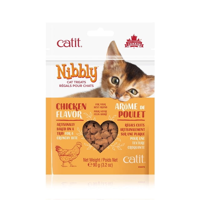 Catit Nibbly Treats for Cats, Chicken Flavour, 90 g package showing a close-up of a cat's face above a heart-shaped transparent window with crunchy, artisanally baked chicken-flavored cat treats made from human-grade ingredients, free of corn, wheat, and soy, and fortified with taurine to support heart, kidney, and liver function, suitable as a crunchy snack for cats.