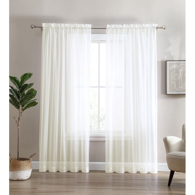 Sheer Window Panel Curtain- 2 Pack in white sheer voile fabric with rod pocket design, gently filtering natural light through a window in a modern living room with light wood flooring, a potted plant, and a beige armchair, ideal for enhancing privacy while maintaining brightness.