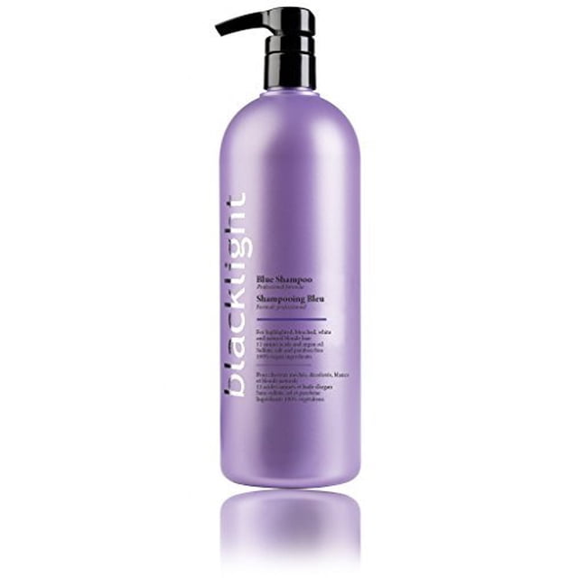 Oligo Blacklight Blue Shampoo for Blonde Hair in a 32oz professional size bottle. This vegan-friendly, sulfate-free shampoo is designed for light brown to medium blonde hair, featuring a purple-toned formula to eliminate brassiness, preserve color, and strengthen hair structure. The bottle has a pump dispenser and a sleek lavender design with white text branding.