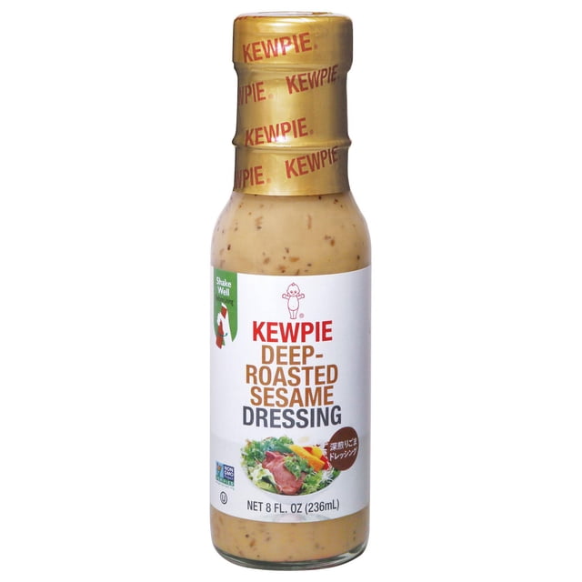 Kewpie deep roasted sesame dressing in a clear glass bottle with a gold foil cap printed with red Kewpie logos, creamy beige dressing with visible roasted sesame seed bits, labeled with the Kewpie logo, product name, salad image, and 236ml volume, ideal for salads, cold pasta, veggie dips, slaws, or meat marinades.