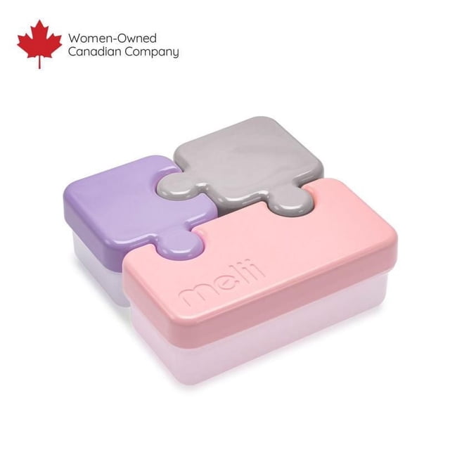 melii Puzzle Bento Box Container for Kids with three airtight, leakproof compartments in pink, purple, and grey that snap together like puzzle pieces, featuring embossed melii branding, microwave and dishwasher safe, ideal for portioned snack and lunch storage.