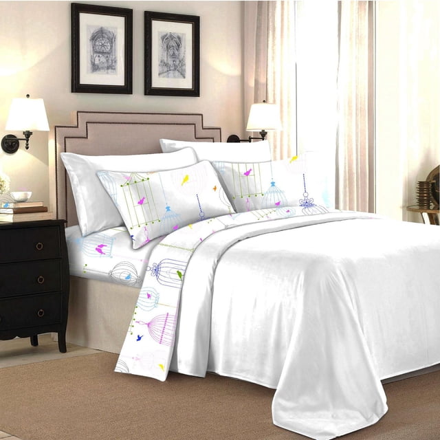 Johnson Home 200 TC Bed Sheet Set - Printed Cotton Sheets on a bed with beige upholstered headboard, featuring white sheets and pillowcases printed with colorful birds and birdcages. Made from breathable, lightweight cotton with 200 thread count for softness and durability. The set complements bedroom decor with cream curtains, black nightstand, and framed art, ideal for year-round use and easy machine care.