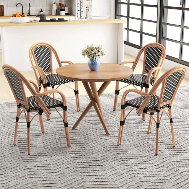 Gymax Outdoor French Bistro Chairs 4 PCS with armrests, featuring a galvanized metal frame and black and white hand-woven PE wicker. The chairs have a wood-like frame finish and ergonomic design with a 105° angled backrest and armrests for comfort. Each chair measures 22'' x 23'' x 35'' (L x W x H) and supports up to 400 lbs. Displayed in a modern indoor setting with a round wooden table on a textured rug.