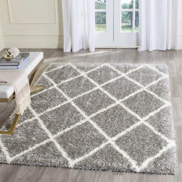 Safavieh Montreal Vesela Geometric Shag Area Rug with plush pile in light grey and white diamond pattern on a light wood floor, suitable for contemporary or transitional accent rug settings.