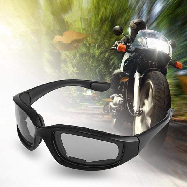 Motorcycle Windproof Protective Goggles Accessories Anti-sand Riding Glasses Transparent with black plastic frame and transparent lenses. Designed for motorcycle protective gear, featuring rubber padding for comfort and ventilation holes to prevent fogging. Suitable for outdoor activities and motorcycle riding. Displayed in front of a blurred motorcycle riding scene.