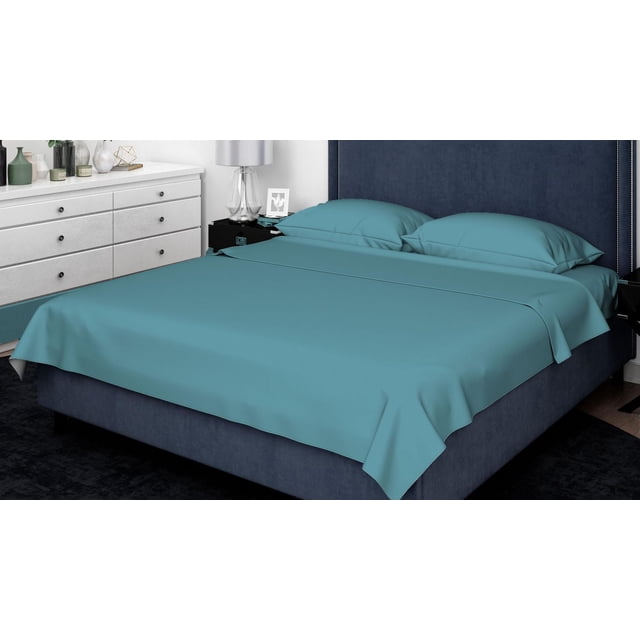 Johnson Home 500 Thread Count Combed Cotton Sheet Sets in muted blue on a queen bed with navy upholstered headboard and silver nailhead trim, featuring matching pillowcases and flat sheet in a modern bedroom with white dresser, highlighting breathable, durable cotton fabric ideal for year-round comfort.