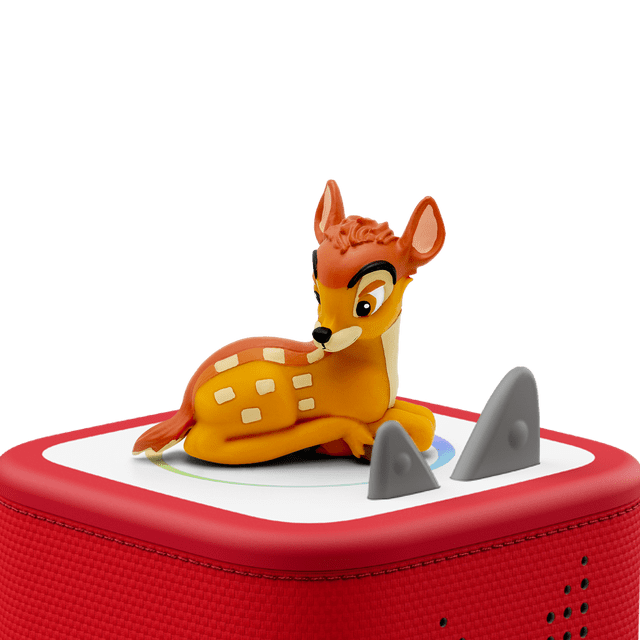 Tonies FRENCH - Bambi collectible figurine in multicolour, showing a small orange and yellow fawn with white spots lying on a red and white Toniebox audio base with grey control ears, designed for educational electronics and screen-free entertainment for kids ages 3 and up.