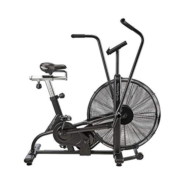 ASSAULTFITNESS Assault AirBike Classic, Black front-facing exercise bike with large fan wheel and dual-action handles; heavy-duty steel frame with industrial powder-coat finish, reinforced pedals and cranks, 20 sealed bearings; console displays time, distance, calories, watts, RPM and speed; 59.95 L x 23.34 W x 50 H inches; designed for interval training and full-body cardio and often used as a compact conditioning tool for garage gyms.