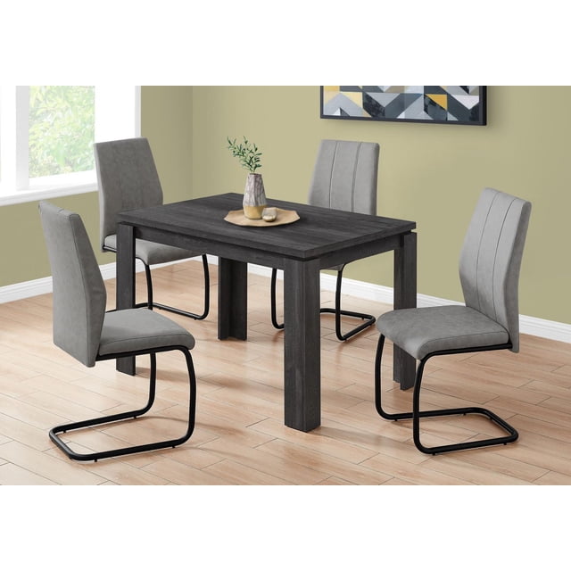 Monarch Specialties Dining Table, 48 inch rectangular small kitchen and dining room table in black laminate with thick block legs and reclaimed wood look surface, paired with four grey upholstered cantilever chairs on light wood flooring in a modern room with green walls and geometric wall art, suitable for casual or formal dining.