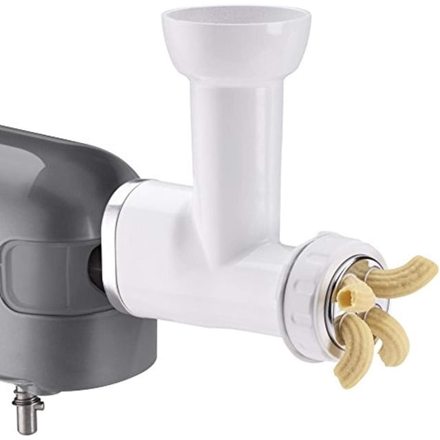 Cuisinart Precision Master Stand Mixer Pasta Extruder Attachment in white plastic connected to a gray stand mixer hub, extruding fresh macaroni pasta through a metal plate with three curved tube shapes, includes six interchangeable pasta plates for versatile pasta making.