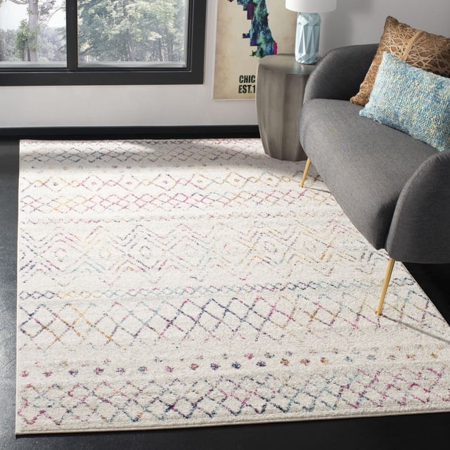 Safavieh Madison Hannah Geometric Area Rug with a cream base and multicolored geometric diamond patterns in pastel shades, power loomed for durability, displayed in a modern living room under a gray sofa with gold legs and decorative pillows, ideal for enhancing contemporary accent rug spaces.