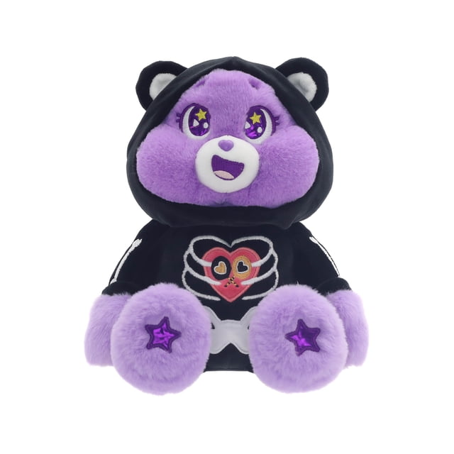 Care Bears Dress-Up Skeleton Plush Toy for Halloween front-facing seated Care Bears plush in a black skeleton costume with white bone print and purple hood; embroidered heart on belly, cheerful stitched smile, soft fur texture and rounded ears, isolated on white background; suitable as a seasonal cuddle companion or trick-or-treat accessory.