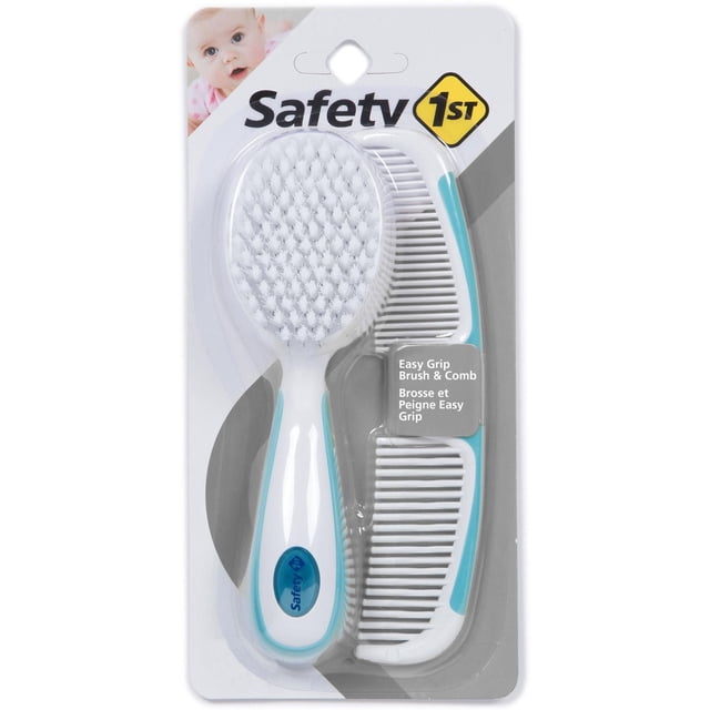 Safety 1st Easy Grip Brush Comb set with a white hairbrush featuring extra-soft bristles and a white comb with dual-density teeth for detangling, both with ergonomic white and light blue soft-touch handles, displayed on branded packaging.