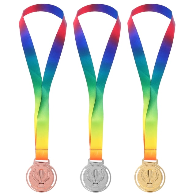 3pcs Trophy Pattern Medal Gold Silver Bronze Medals Hanging Medal Awards Medals. This set includes three zinc alloy medals in gold, silver, and bronze, each with a trophy design and attached to a rainbow-colored ribbon. Measuring approximately 7.00x6.50x0.40cm, these medals are sturdy and long-lasting, making them perfect for recognizing achievements in sports or team events. They are also a thoughtful gift for children or participants, symbolizing success and effort.