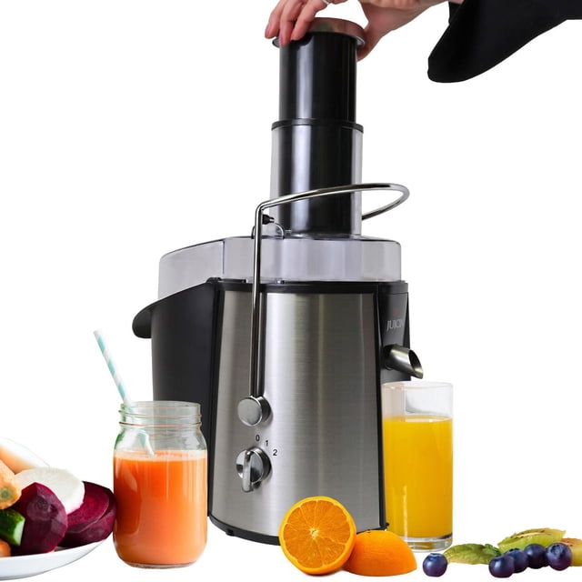 Total Chef 700W Juicin' Power Juicer with surgical steel blade and dual speed control, featuring a wide 3-inch feeding chute pressed by a hand, stainless steel body with black accents, shown with fresh orange and mixed fruit juices in glassware, surrounded by fresh fruits including orange, blueberries, kiwi, carrot, and beetroot on a white background.